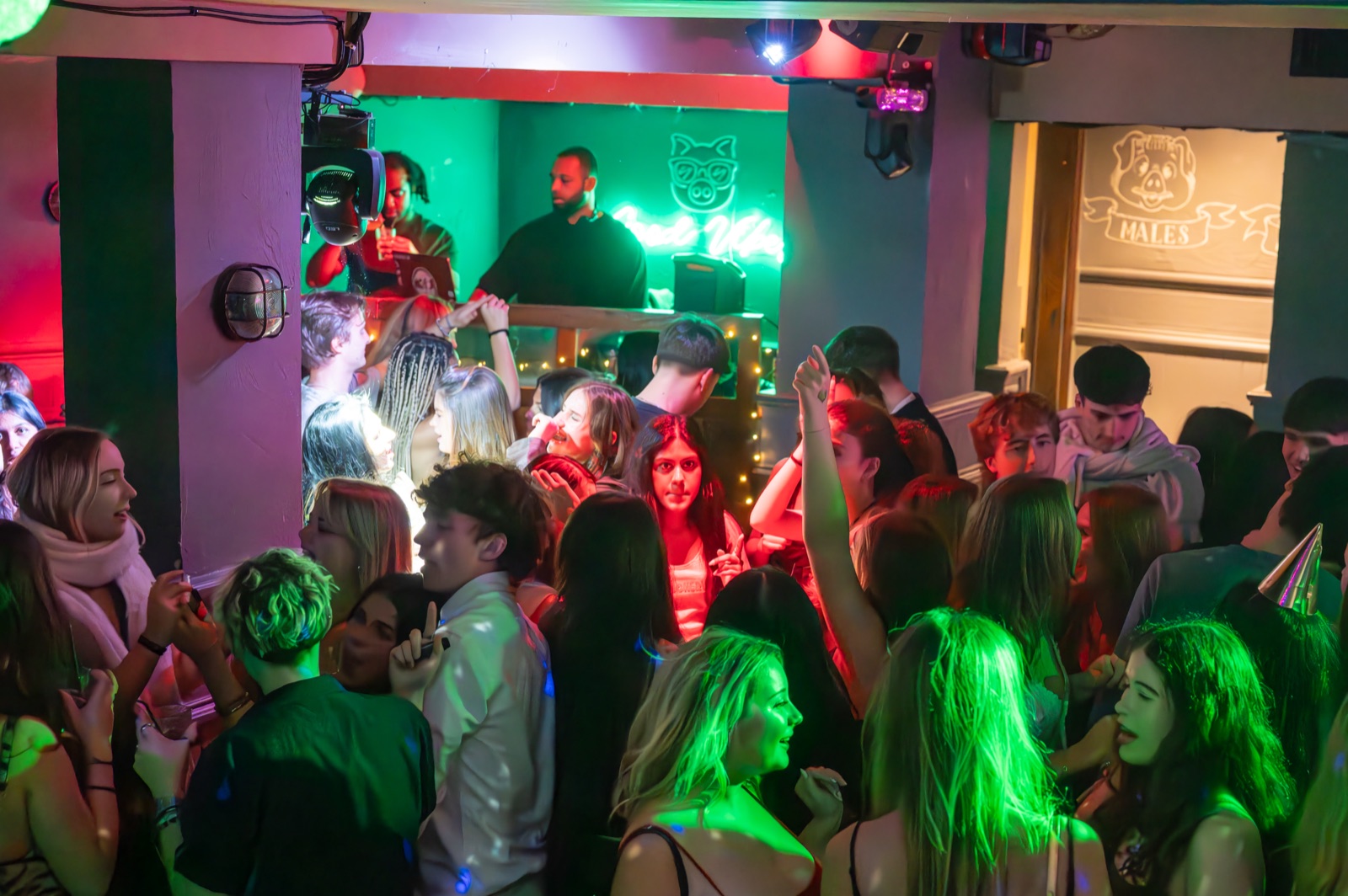 Students dancing under disco lights at OMP Mondays